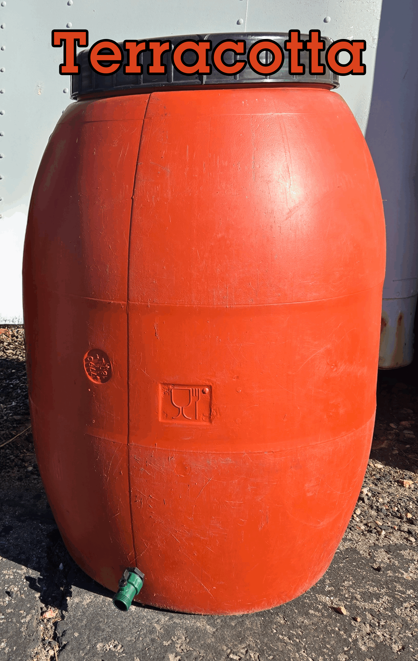 A terracotta colored rain barrel. The color is labelled on the picture.